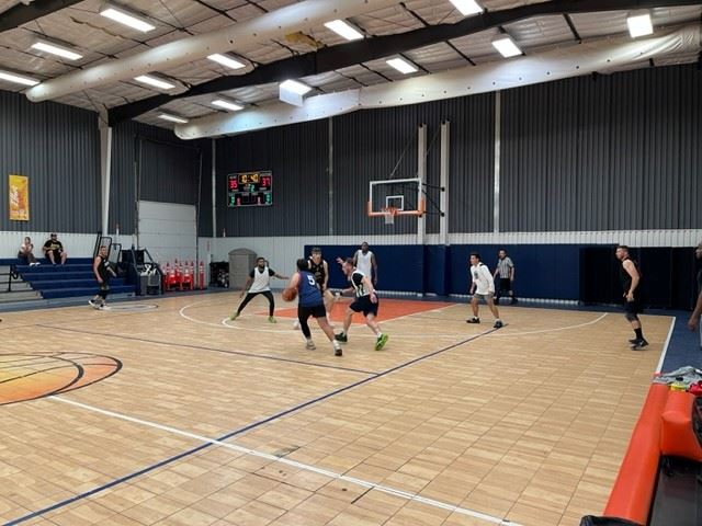 playing basketball on an indoor court